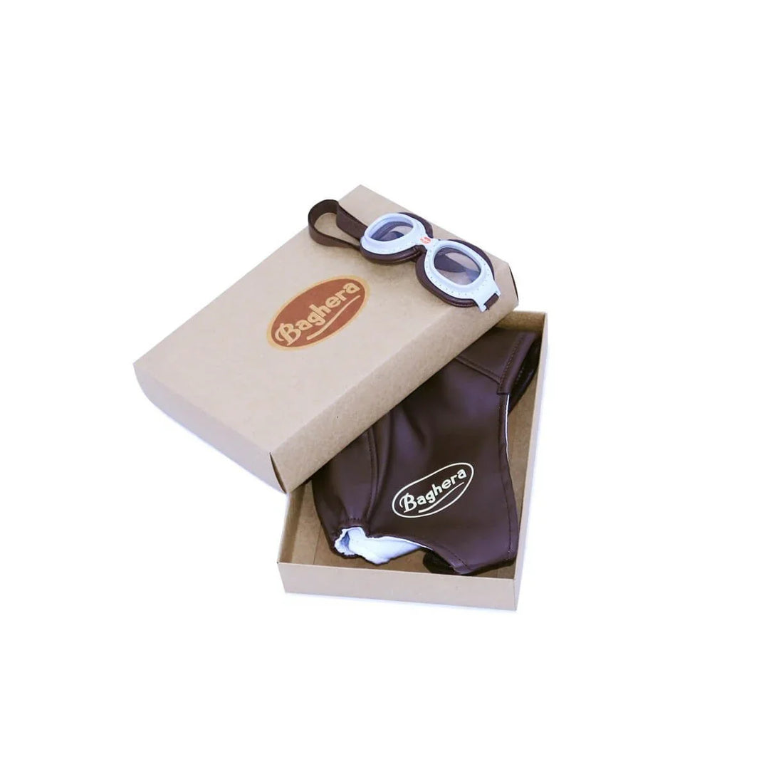 Box containing Baghera branded racing kit goggles and hat on a white background