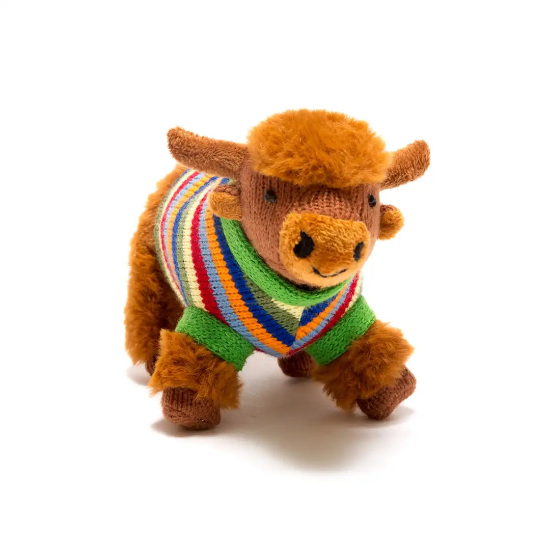 Best Years stuffed Highland cow rattle with a colourful sweater on a white background