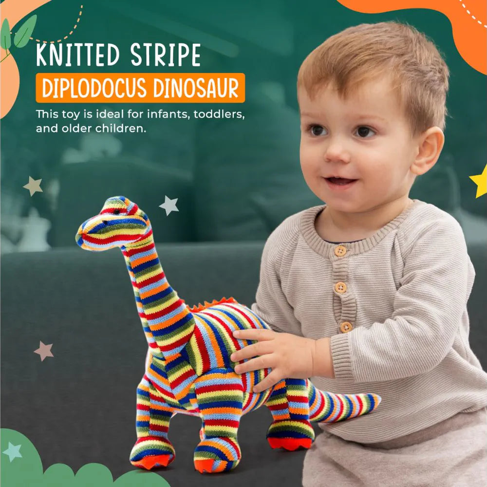 Best Years colourful knitted plush dinosaur toy with horizontal stripes in red, orange, yellow, green, blue, and white, standing on a white background with child