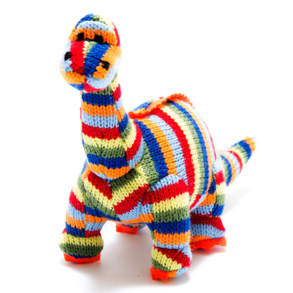 Best Years knitted diplodocus dinosaur toy with a colourful striped pattern of red, orange, yellow, green, blue, and white, standing on a white background.