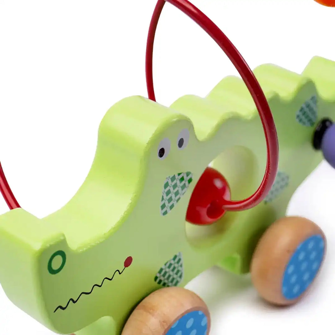 Bigjigs Toys children's push along green crocodile with colourful beads on a white background