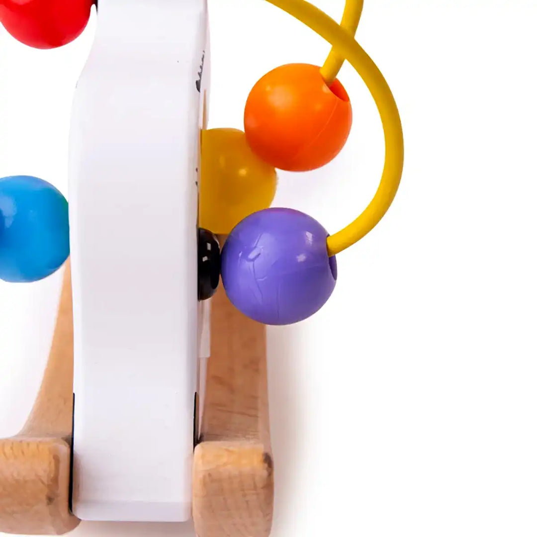 Bigjigs Toys wooden rocking cow bead frame with colourful beads on a white background