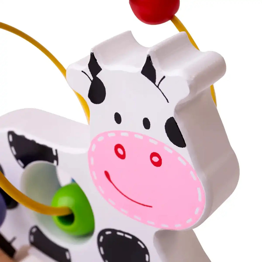 Bigjigs Toys wooden rocking cow bead frame with colourful beads on a white background