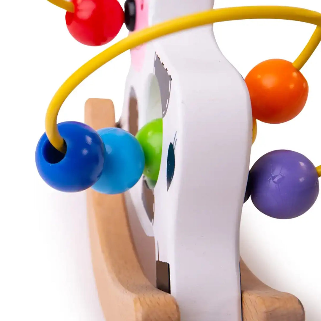 Bigjigs Toys wooden rocking cow bead frame with colourful beads on a white background