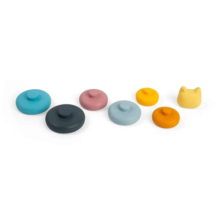 Set of colourful Bigjigs toys silicone stacking shapes with a cat-shaped lid on a white background