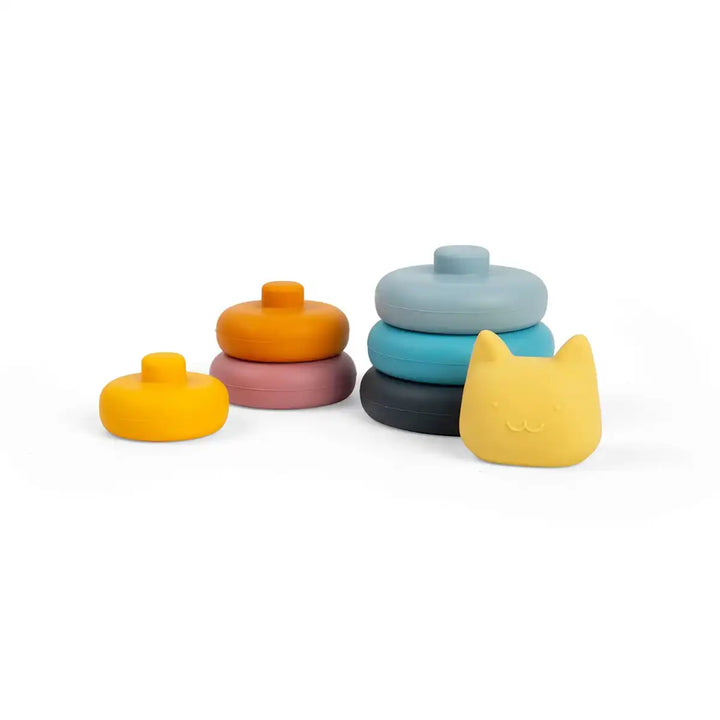 Set of colourful Bigjigs toys silicone stacking shapes with a cat-shaped lid on a white background