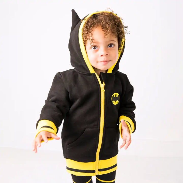 Child wearing a Blade and Rose black and yellow hoodie with a Batman logo on a white background
