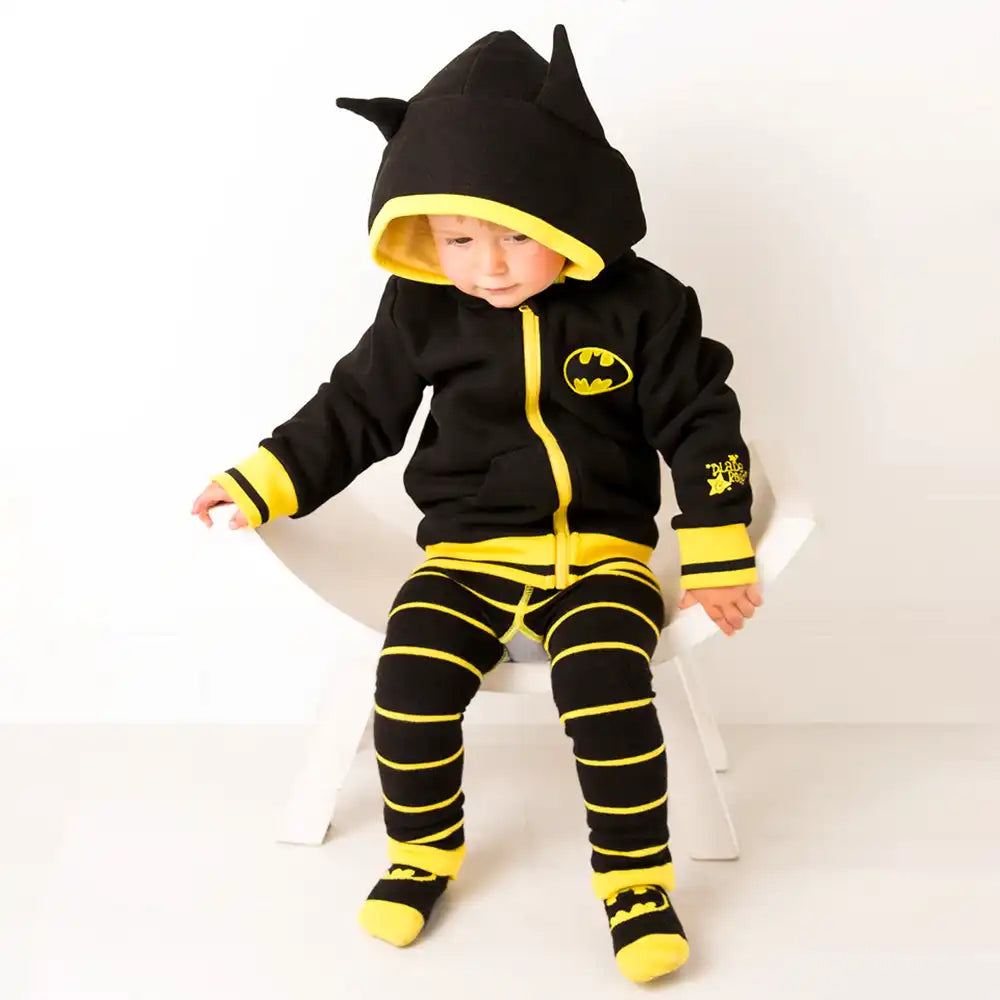 Child wearing a Blade and Rose Batman-themed hoodie and leggings set on a white background
