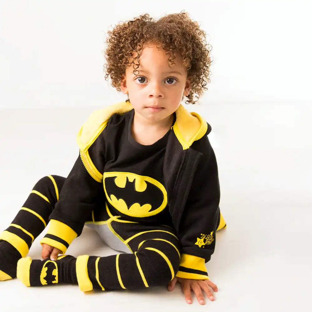 Child wearing a Blade and Rose black and yellow superhero costume with a prominent logo on a white background