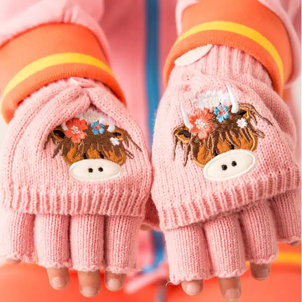 Pair of pink Blade & Rose Bonnie Highland Cow knit fingerless gloves with cow design being worn by a child