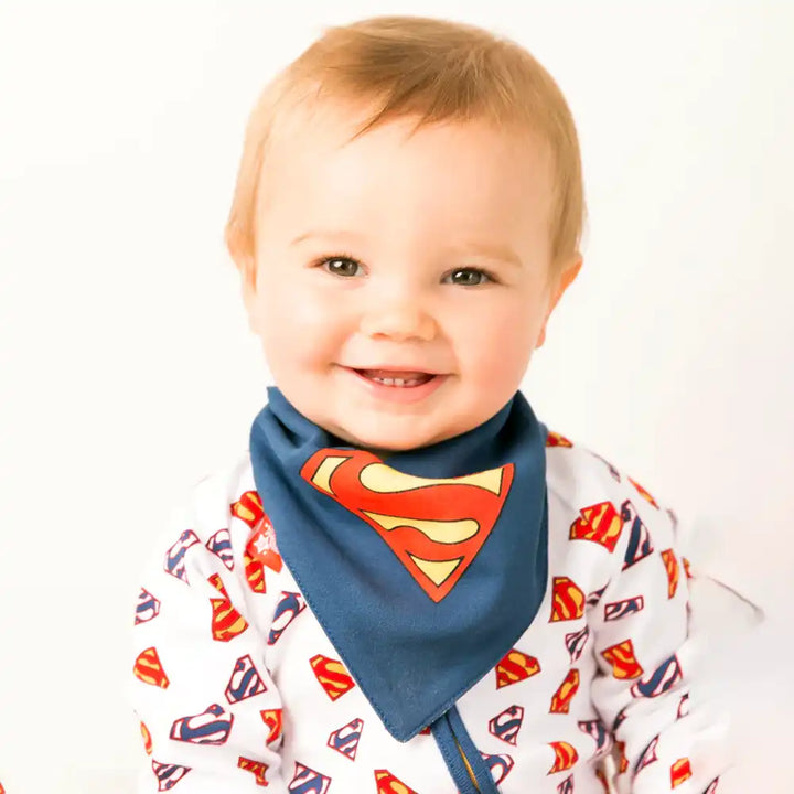 Child wearing a Blade and Rose Superman-themed bib and shirt on a white background