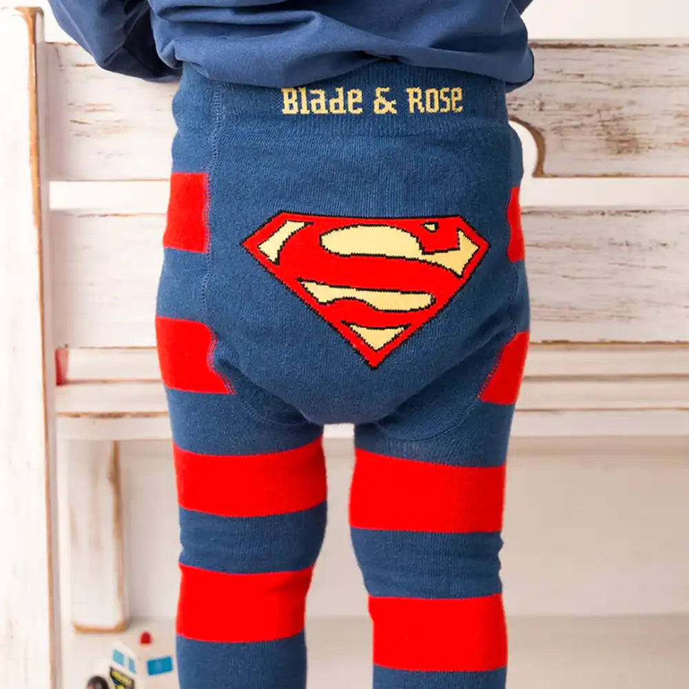Blade and Rose Superman-themed leggings with red and blue design, worn by a person, on a wooden floor background.