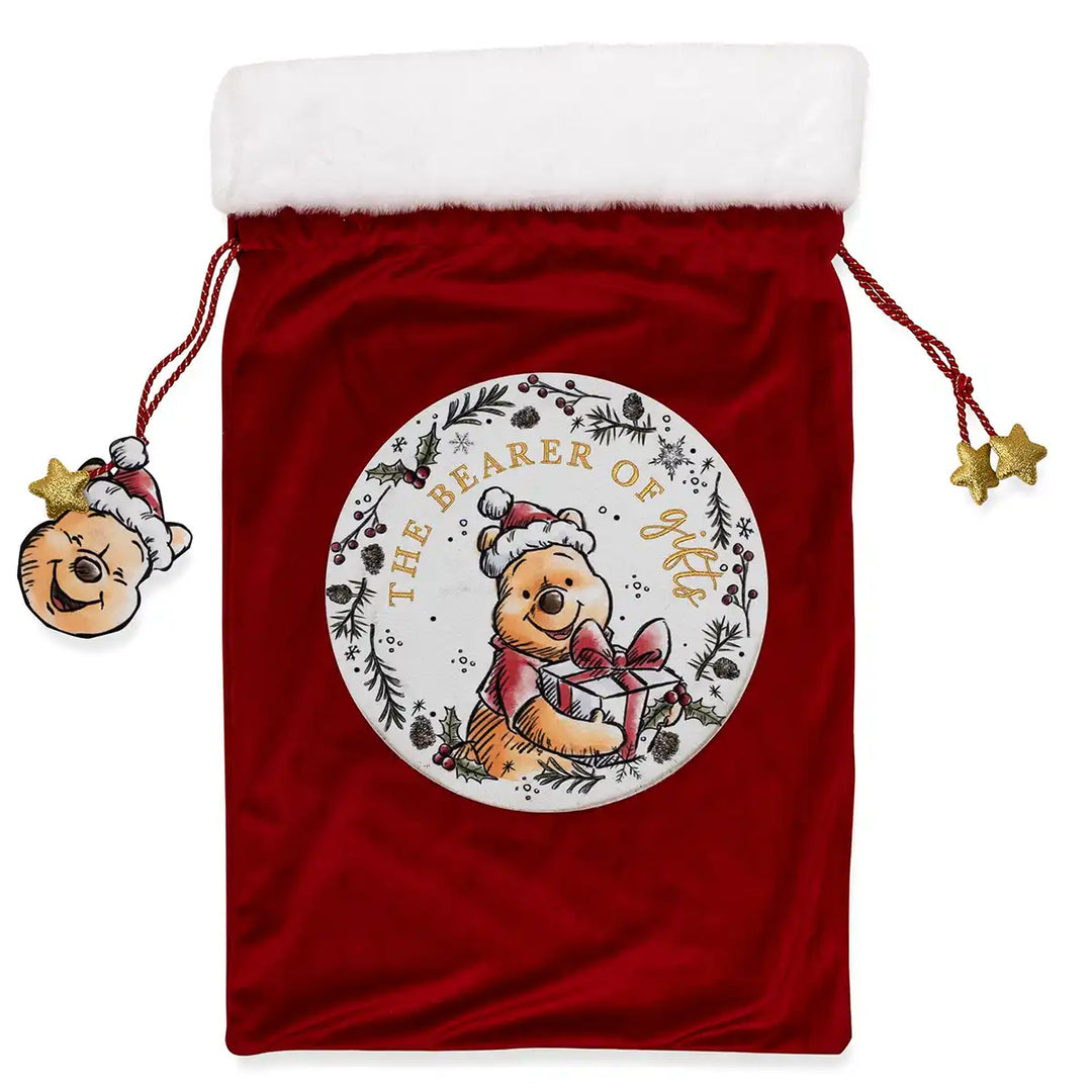 Red velvet drawstring bag with a Christmas-themed Disney Winnie the Pooh bear and text, on a white background.