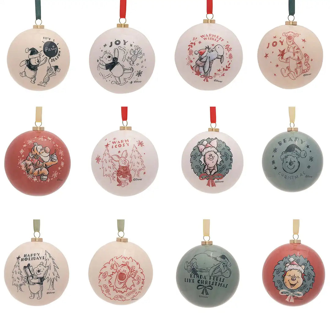 Set of round Disney Winnie the Pooh Christmas ornaments with various designs on a white background