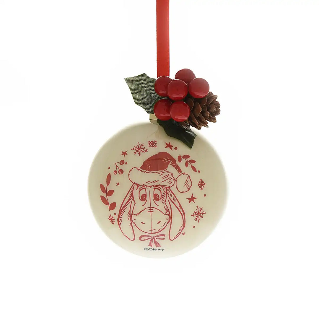 Winnie the Pooh Christmas ornament with a red Eeyore design, red berries, and holly leaves on a white background.