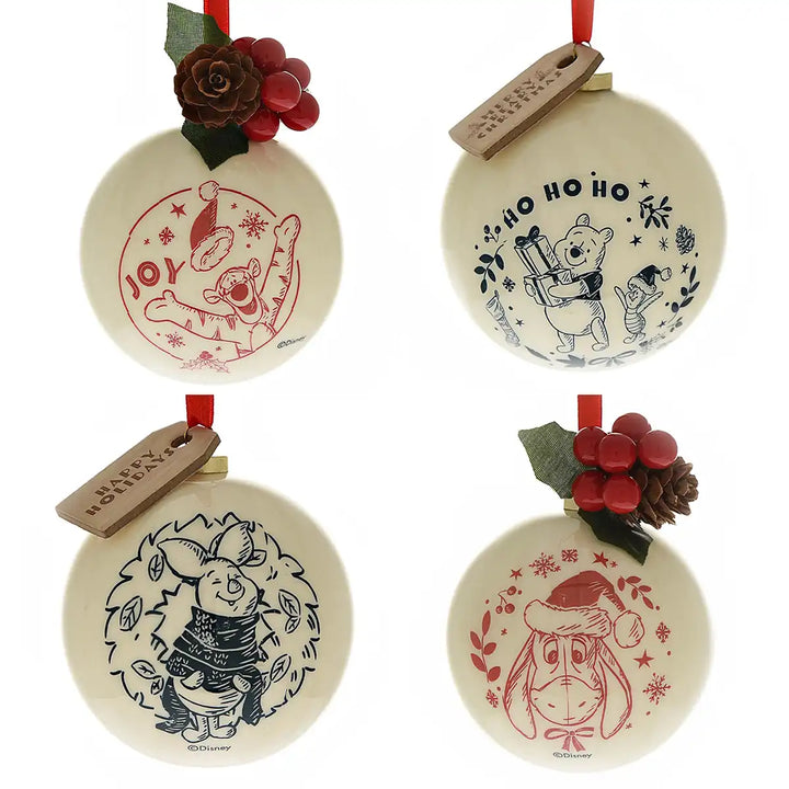 Set of four Christmas-themed plastic ornaments with Winnie the Pooh designs on a white background.