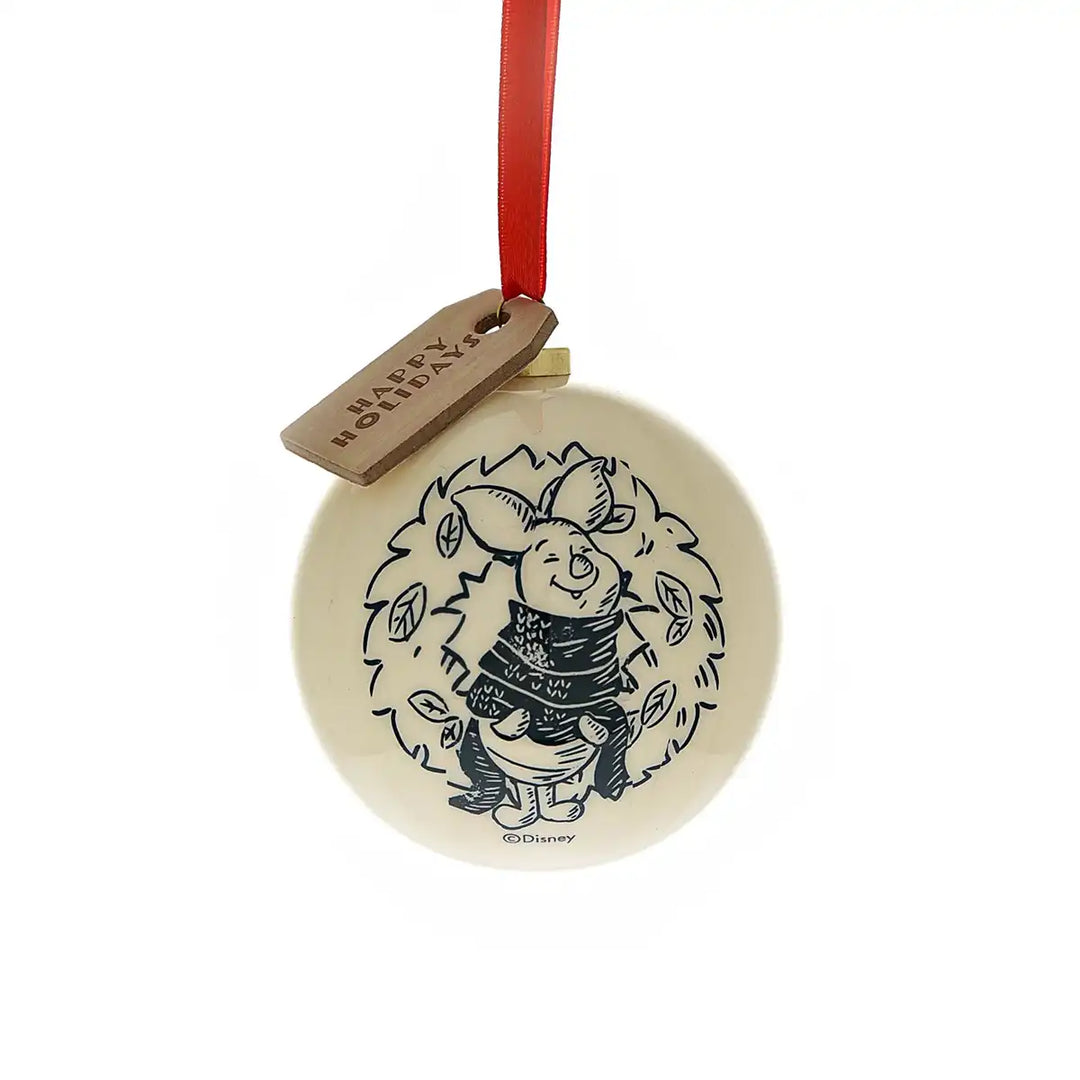 Round ceramic Winnie the Pooh ornament with a festive design with Piglet and red ribbon on a white background