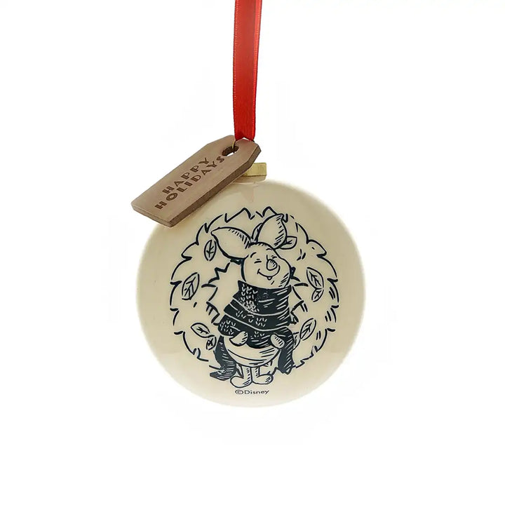 Round ceramic Winnie the Pooh ornament with a festive design with Piglet and red ribbon on a white background