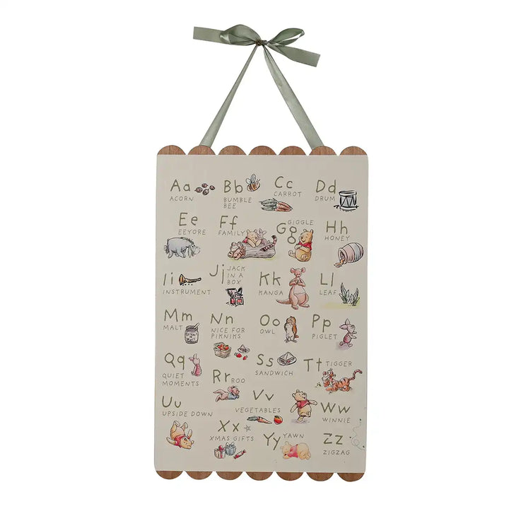 Disney Winnie the Pooh children's alphabet chart with illustrations and a green ribbon on a white background