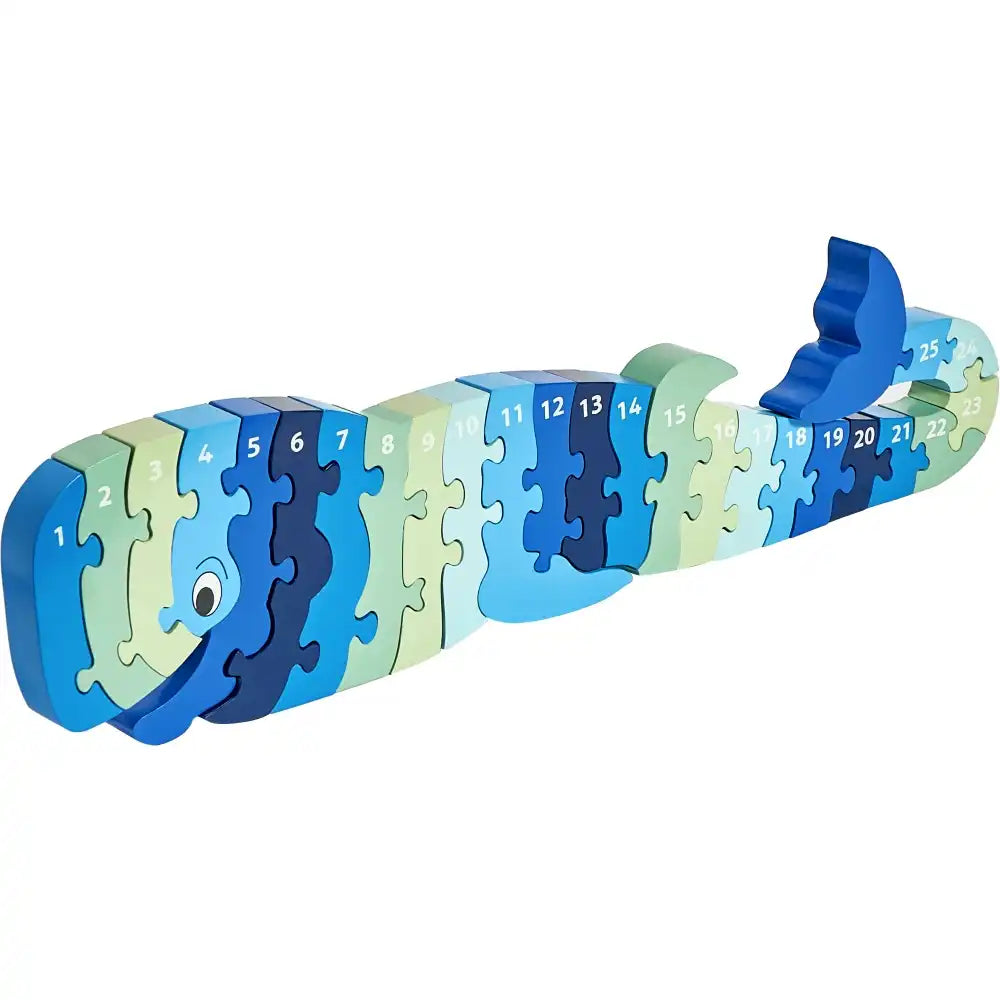 A Lanka Kade wooden Whoopi the whale puzzle toy made of numbered interlocking pieces in shades of blue, navy, and light green, shown on a plain white background.