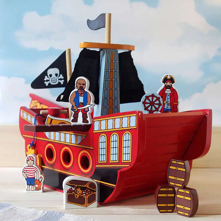 Lanka Kade wooden pirate ship toy with figures and accessories on a wooden surface