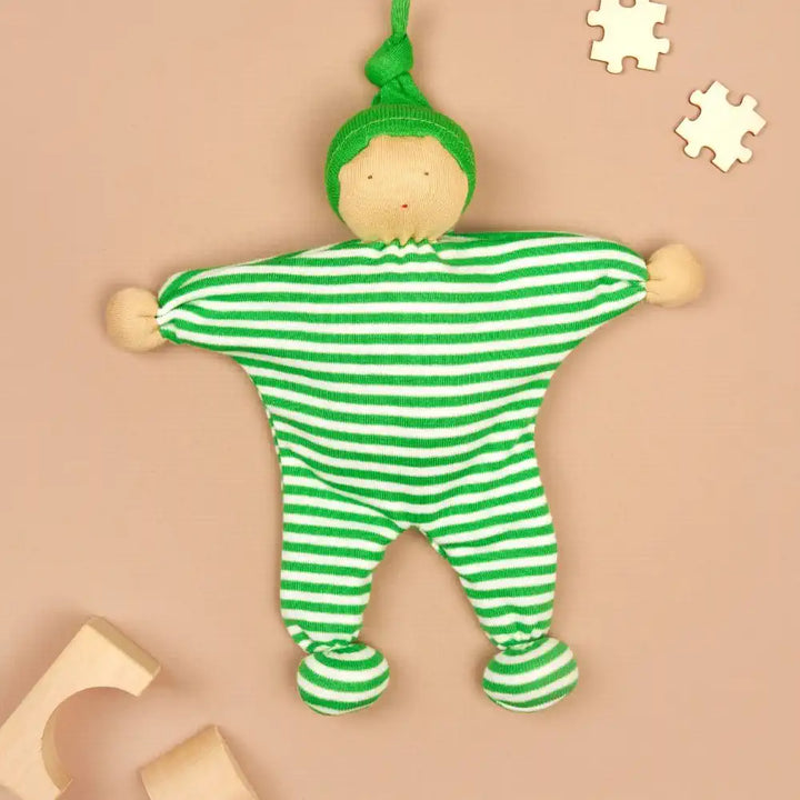 Under the Nile green and white striped baby buddy comforter with a matching hat on a coloured background
