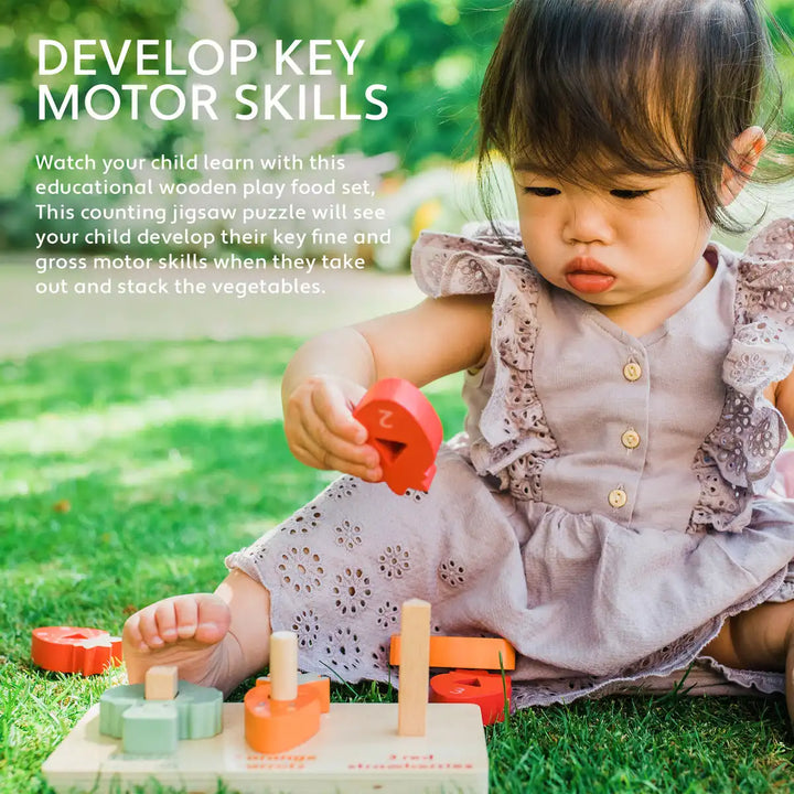 Child playing with an Orange Tree Toys counting veggies puzzle on the grass