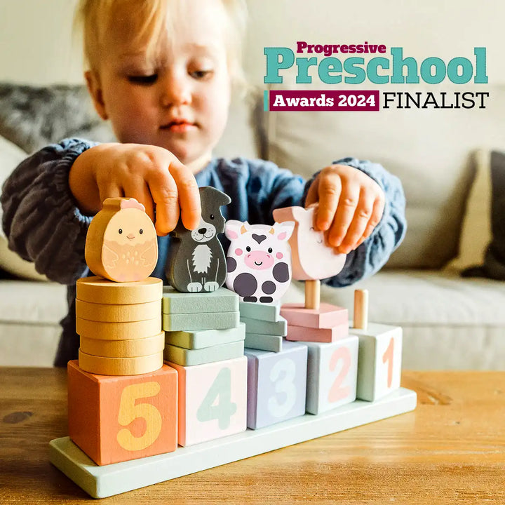 Child playing with Orange Tree Toys wooden animal counting game blocks on a table, with 'Progressive Preschool Awards 2024 Finalist' text above.