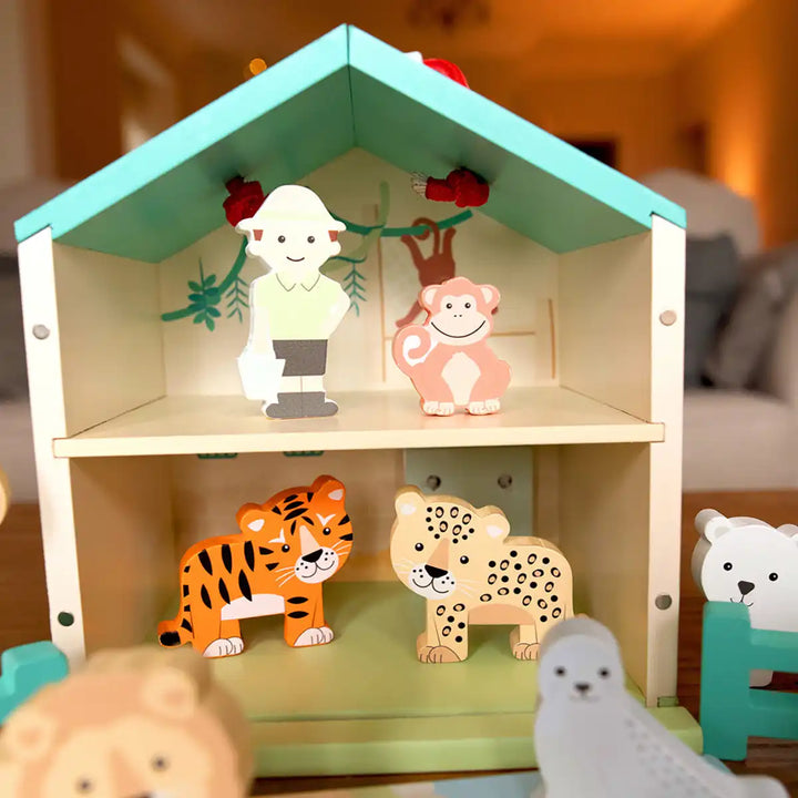 Orange Tree Toys zoo toy play set with animal figurines on a blurred  background