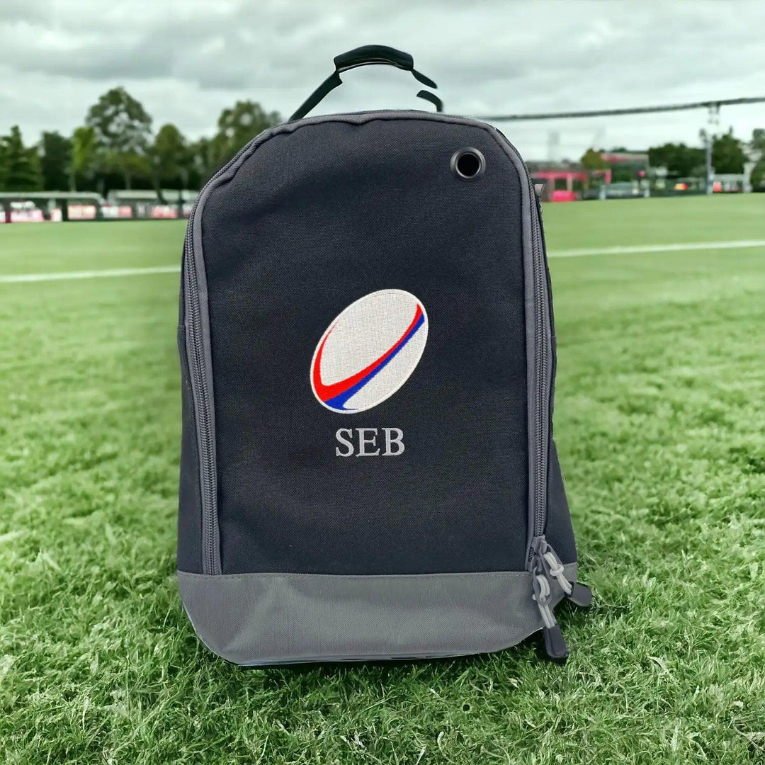 Personalised embroidered rugby boot bag in black and grey with the name Seb in polished pewter