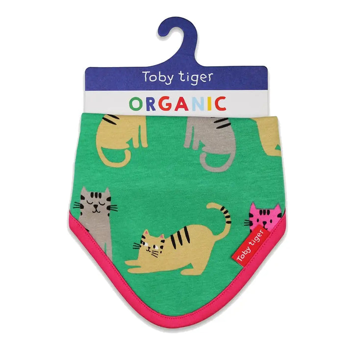 Toby Tiger organic baby bib with cat designs on a green background, hanging on a 'Toby Tiger' hook.