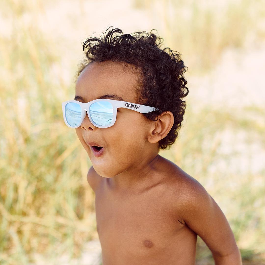 Babiators blue series navigator sunglasses in the ice breaker white being worn boy