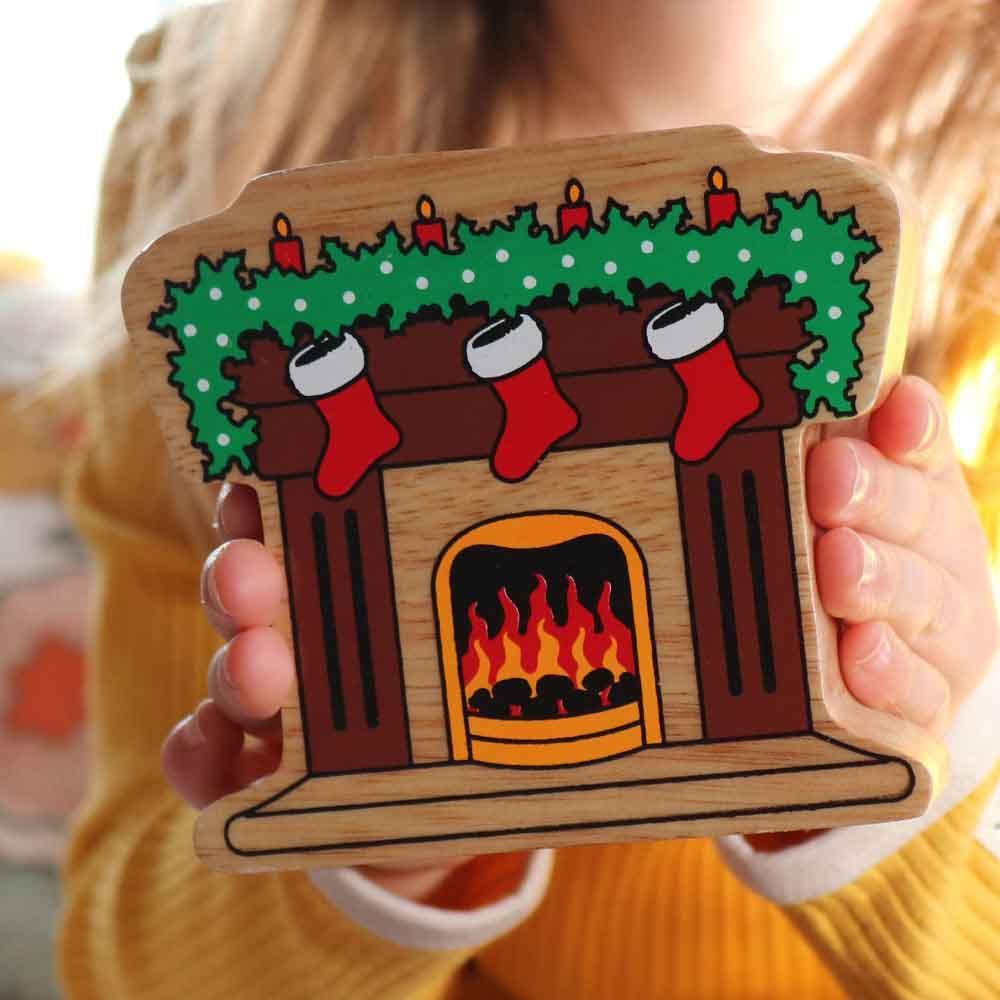 Lanka Kade Natural Wooden Colourful Fireplace with Stockings Christmas Figure Being Held Picture